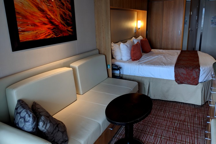 view inside Celebrity Eclipse stateroom with balcony