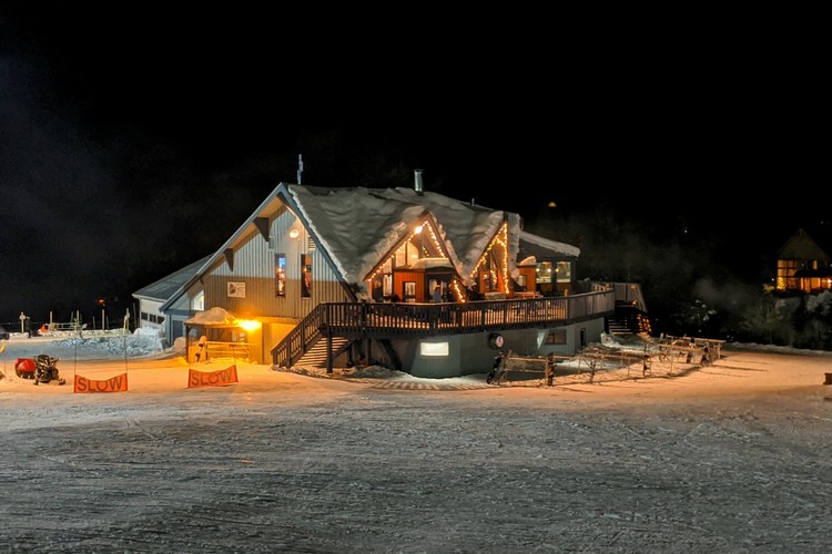 night photo of Sasquatch Mountain lodge at the base of the ski mountain