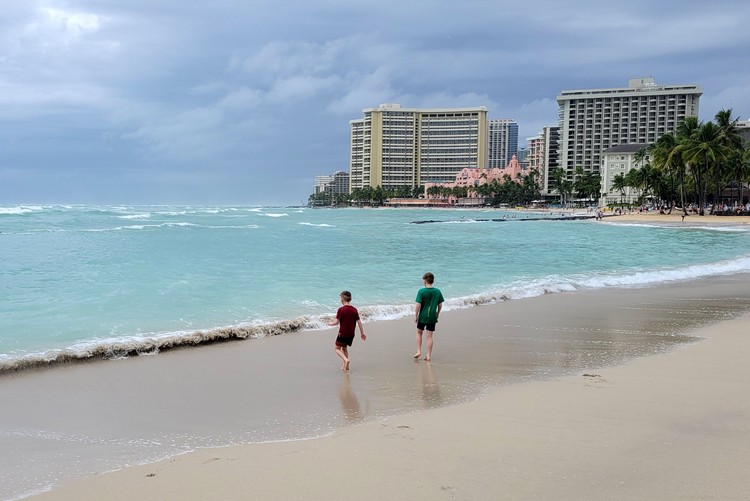 kids on Waikiki Beach during storm, Honolulu Hawaii travel right now
