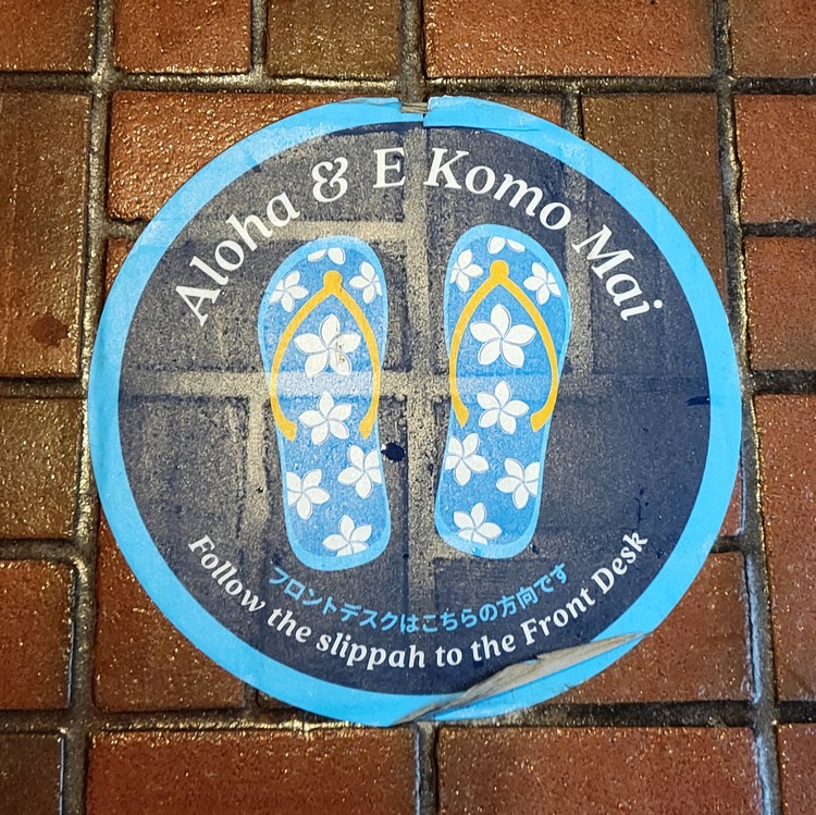 travel requirements to Oahu Hawaii, social distancing sticker on the sidewalk with flip flops