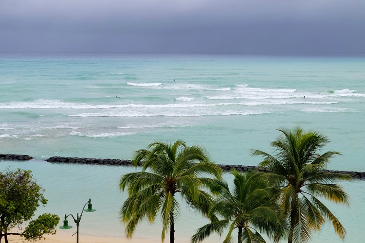 surfers at Waikiki Beach during storm, Oahu Hawaii