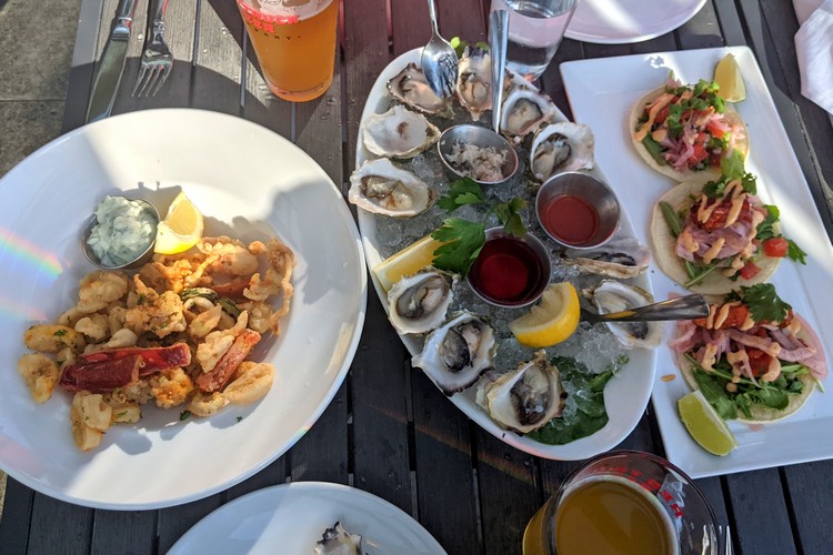 fresh oysters, fried calamari and fish tacos at Pier & restaurant at The Shipyards District in Lower Lonsdale North Vancouver