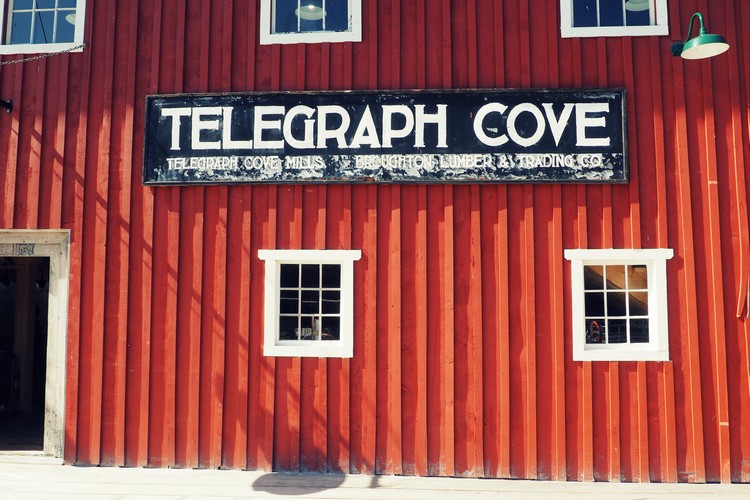 Telegraph Cove sign on the red building on the boardwalk