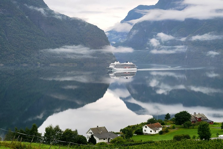 Norway cruise ship sailing through Aurlandsfjord to port in Flam, Norway