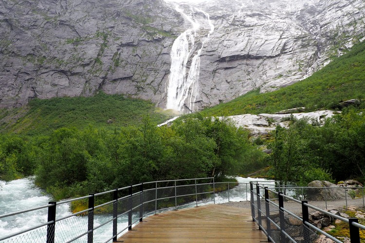 Bridge and waterfall at Briksdal Glacier. Jostedal Glacier hike in Norway
