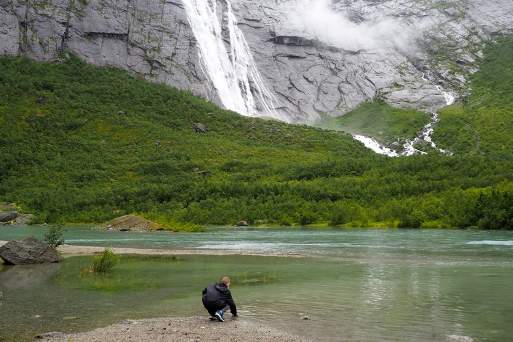 Touching glacier water at Briksdal Glacier in Jostedalsbreen National Park popular Norway hiking trail in Vestland
