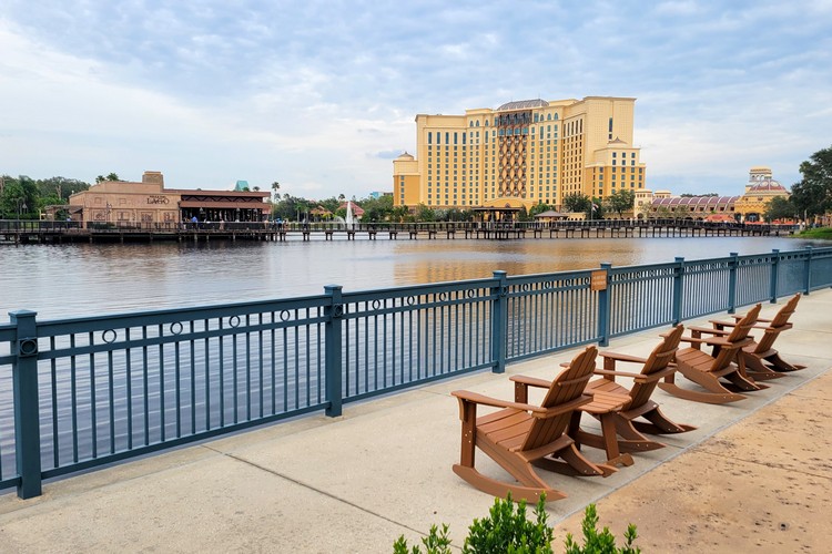 chairs on the path in front of the lake at Disney's Coronado Springs Resort in Orlando Florida