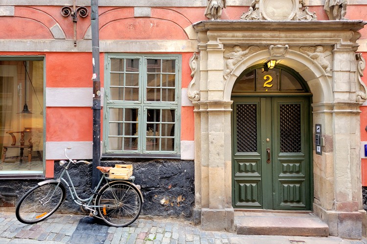 old bicycle and grand entrance to an old building in Gamla Stan Stockholm Sweden