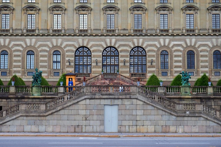 guard watches the entrance to Stockholm Royal Palace in Gamla Stan Old Town 