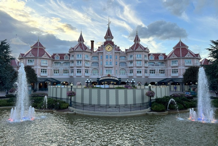 Disneyland Paris hotel at sunset with fountains in the front