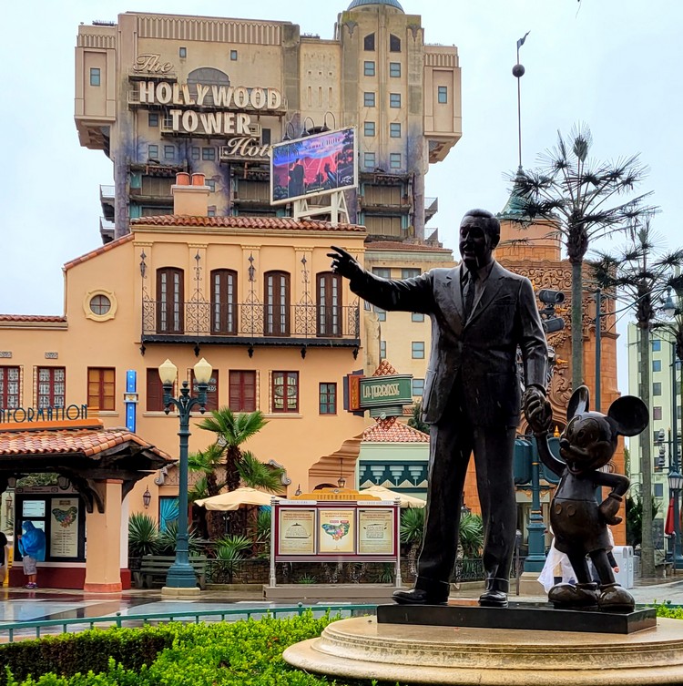 Famous statue of Walt Disney and Mickey Mouse in front of the Hollywood Tower at Paris Disneyland, France