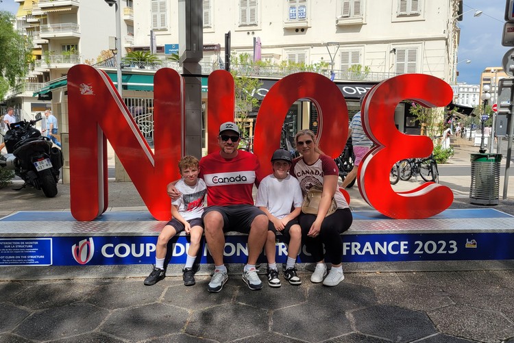 Family photo at Nice sign in Nice, France