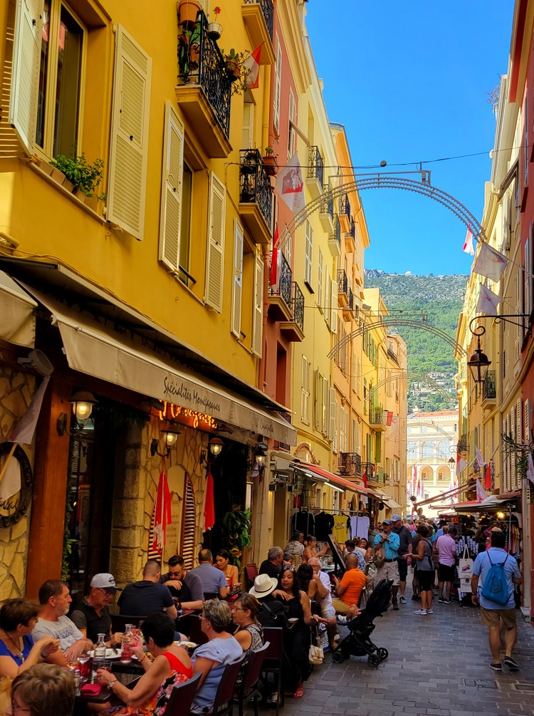 Busy outdoor restaurants and cafes in Monaco's Old Town
