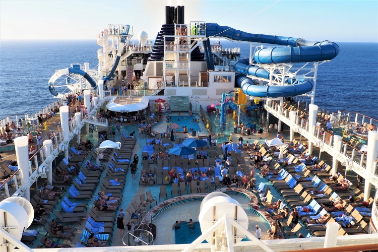 Norwegian Bliss cruise ship pool deck view with waterslides that hang over the ocean