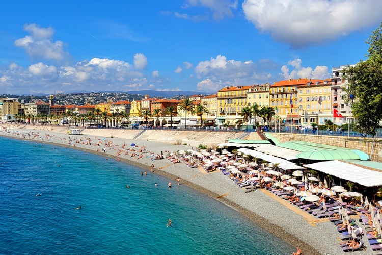 popular beach in Nice France along waterfront promenade near castle hill 